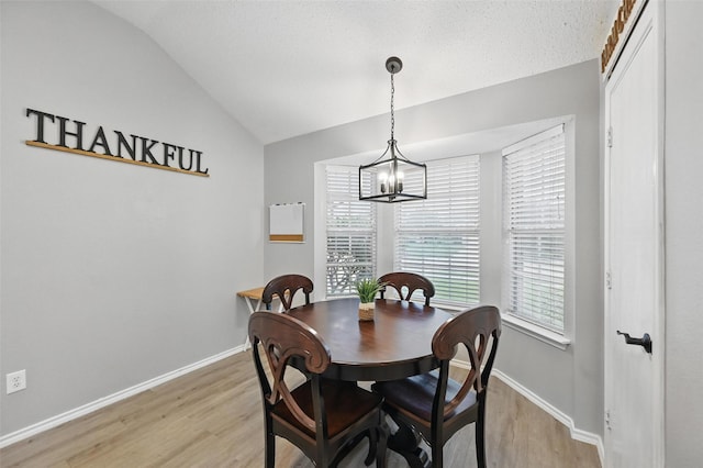 4525 Wheatland Dr, Fort Worth, TX 76179 - dining area with lofted ceiling, light wood-style floors, a chandelier, and baseboards