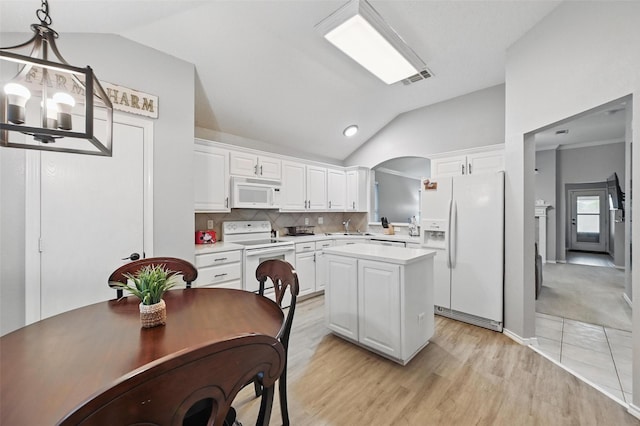 4525 Wheatland Dr, Fort Worth, TX 76179 - kitchen featuring white appliances, vaulted ceiling, light countertops, a sink, and a center island