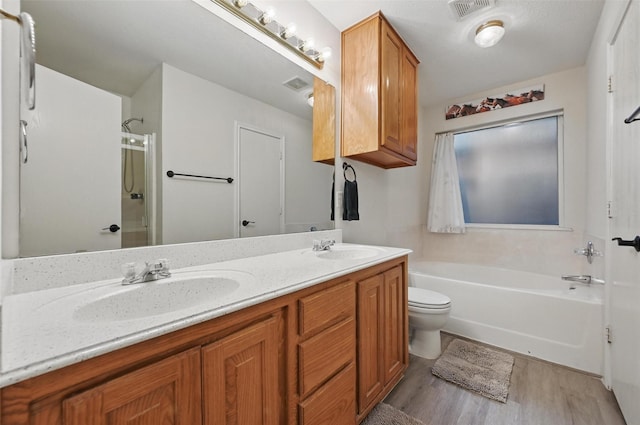 4525 Wheatland Dr, Fort Worth, TX 76179 - bathroom featuring wood finished floors, a shower, toilet, double vanity, and a bathtub