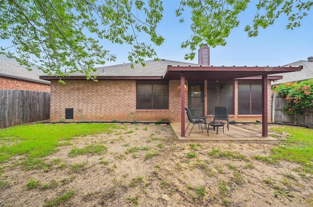 4525 Wheatland Dr, Fort Worth, TX 76179 - back of house featuring a patio area, a fenced backyard, brick siding, and a chimney