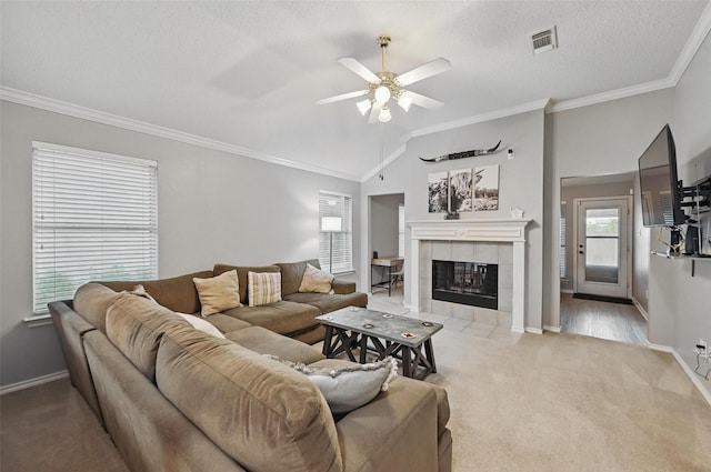 4525 Wheatland Dr, Fort Worth, TX 76179 - living room featuring crown molding, ceiling fan, light carpet, a tile fireplace, and baseboards