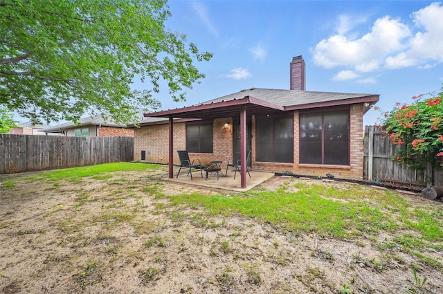 4525 Wheatland Dr, Fort Worth, TX 76179 - back of property with a patio area, brick siding, a chimney, and a fenced backyard