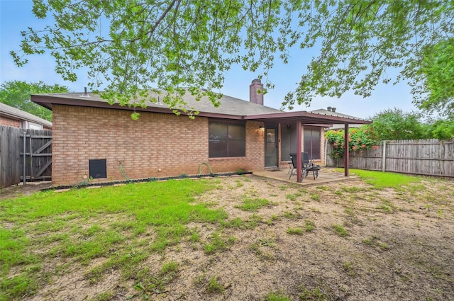 4525 Wheatland Dr, Fort Worth, TX 76179 - back of property with brick siding, a patio, and a chimney