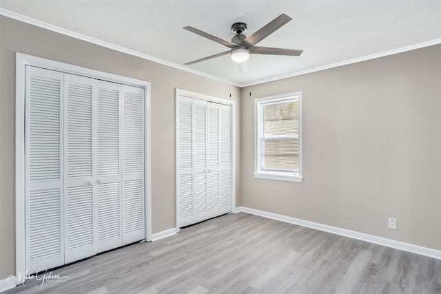 156 Charles Ave, Shreveport, LA 71105 - unfurnished bedroom featuring multiple closets, wood finished floors, ornamental molding, baseboards, and ceiling fan