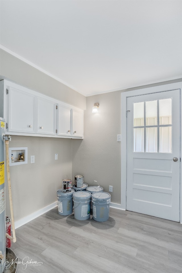156 Charles Ave, Shreveport, LA 71105 - laundry room with washer hookup, light wood-type flooring, baseboards, and cabinet space