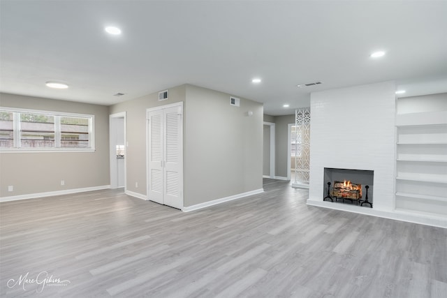 156 Charles Ave, Shreveport, LA 71105 - unfurnished living room with baseboards, light wood finished floors, a fireplace, recessed lighting, and built in features