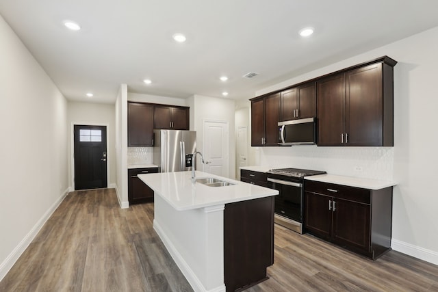 519 Willet Dr, Mckinney, TX 75069 - kitchen featuring stainless steel appliances, a sink, wood finished floors, tasteful backsplash, and recessed lighting