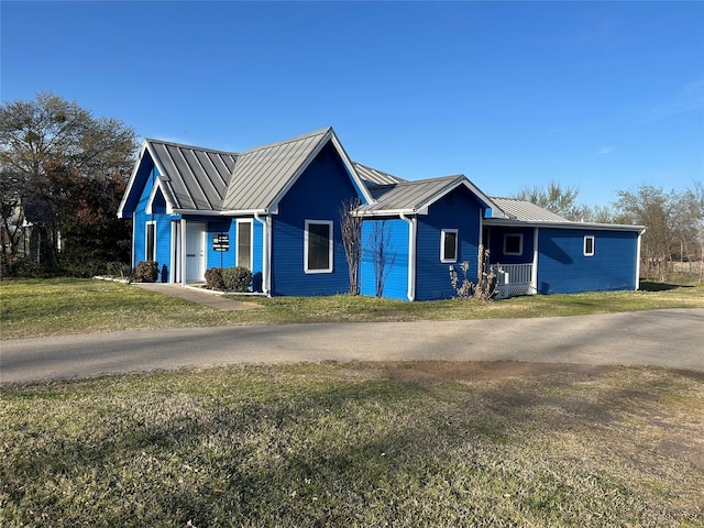 1004 Church St, Sulphur Springs, TX 75482 - ranch-style home with a front yard, a standing seam roof, and metal roof