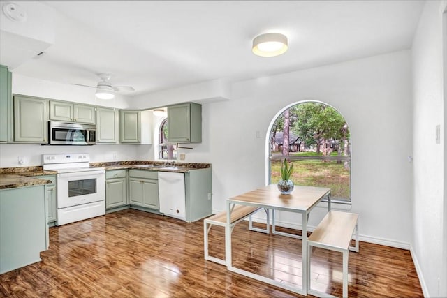 415 Lone Star Ln, Hideaway, TX 75771 - kitchen featuring white appliances, green cabinetry, dark wood-style flooring, ceiling fan, and baseboards