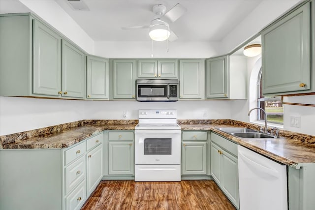 415 Lone Star Ln, Hideaway, TX 75771 - kitchen featuring white appliances, green cabinetry, a sink, ceiling fan, and wood finished floors