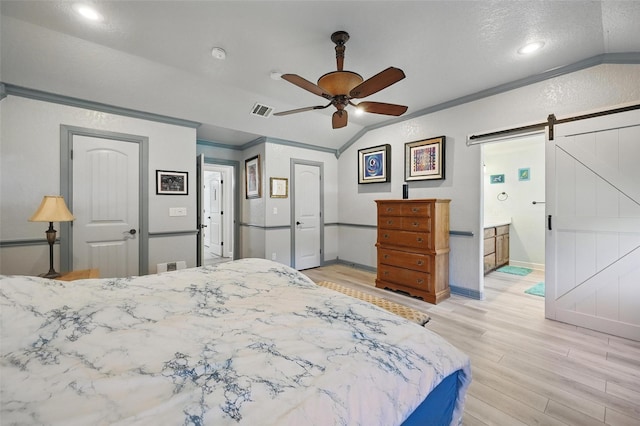 2800 E Fm 4, Cleburne, TX 76031 - bedroom with a barn door, vaulted ceiling, light wood-type flooring, baseboards, and ceiling fan