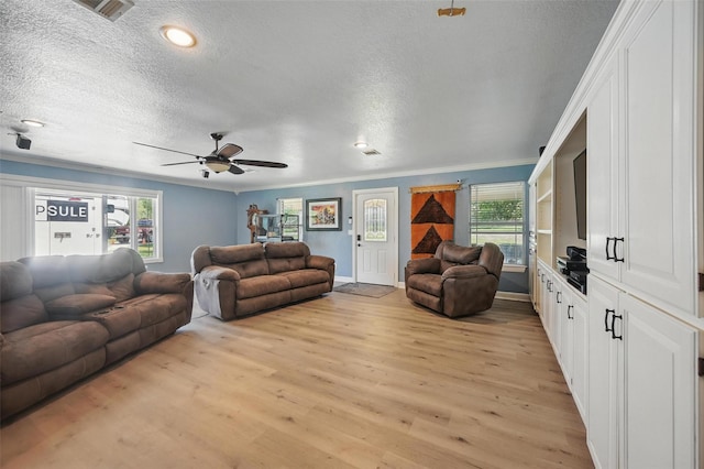 2800 E Fm 4, Cleburne, TX 76031 - living area with a textured ceiling, light wood-type flooring, ceiling fan, crown molding, and baseboards