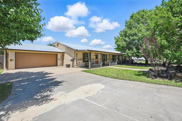 2800 E Fm 4, Cleburne, TX 76031 - ranch-style house with concrete driveway, brick siding, a front lawn, covered porch, and metal roof