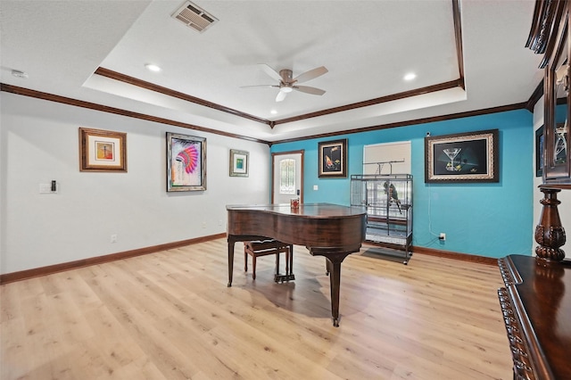 2800 E Fm 4, Cleburne, TX 76031 - sitting room featuring a raised ceiling, ceiling fan, ornamental molding, light wood-style flooring, and baseboards