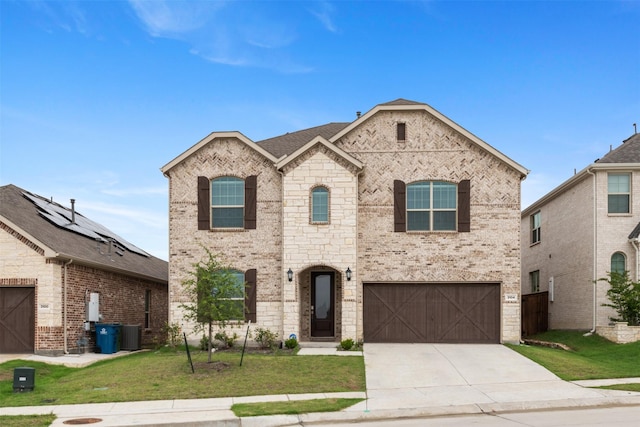 3104 Lakewood Bluffs Trl, Lewisville, TX 75010 - french country home with brick siding, a front yard, an attached garage, concrete driveway, and cooling unit