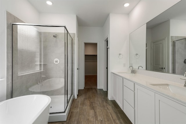 3104 Lakewood Bluffs Trl, Lewisville, TX 75010 - full bath featuring a stall shower, a freestanding bath, double vanity, a walk in closet, and recessed lighting