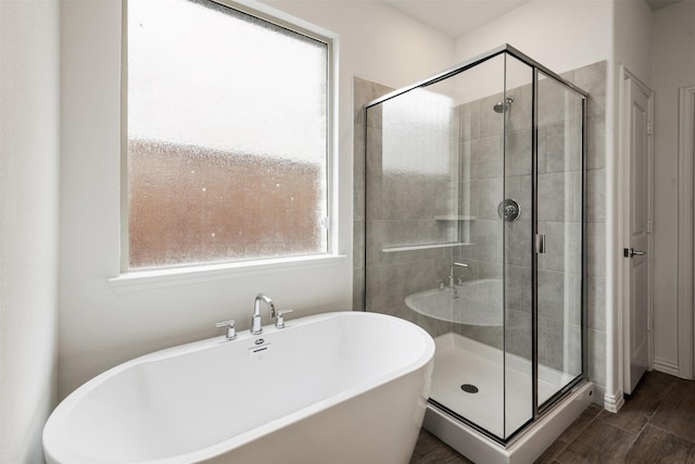 3104 Lakewood Bluffs Trl, Lewisville, TX 75010 - full bathroom featuring a shower stall, a freestanding tub, and wood finished floors