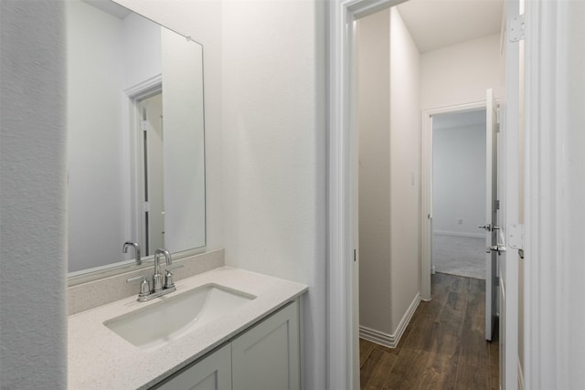 3104 Lakewood Bluffs Trl, Lewisville, TX 75010 - bathroom featuring wood finished floors, vanity, and baseboards