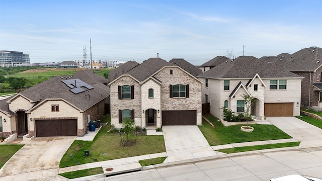 3104 Lakewood Bluffs Trl, Lewisville, TX 75010 - french country inspired facade with concrete driveway, a front lawn, and brick siding