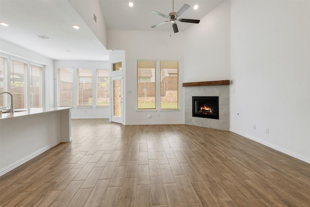 3104 Lakewood Bluffs Trl, Lewisville, TX 75010 - unfurnished living room with ceiling fan, wood finished floors, plenty of natural light, a fireplace, and recessed lighting