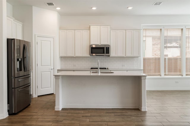 3104 Lakewood Bluffs Trl, Lewisville, TX 75010 - kitchen with stainless steel appliances, light countertops, dark wood finished floors, and recessed lighting