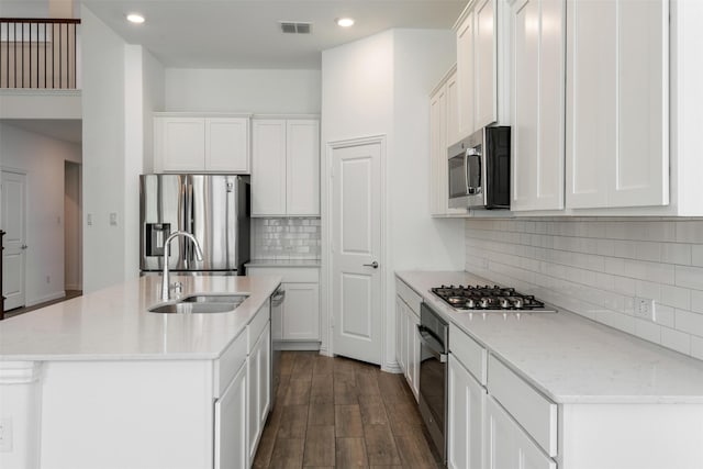 3104 Lakewood Bluffs Trl, Lewisville, TX 75010 - kitchen featuring appliances with stainless steel finishes, a sink, recessed lighting, dark wood-style floors, and white cabinets