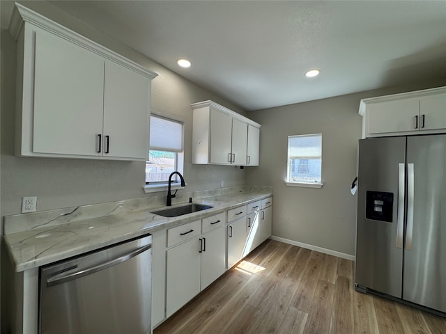 608 S Seaman St, Eastland, TX 76448 - kitchen featuring stainless steel appliances, a sink, plenty of natural light, light wood-type flooring, and recessed lighting