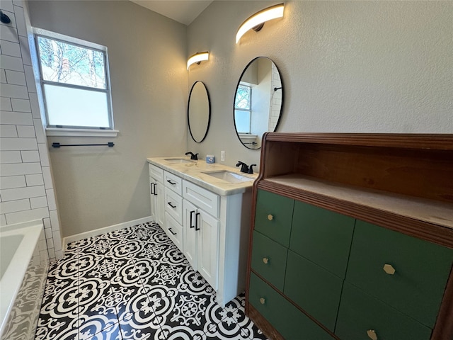 608 S Seaman St, Eastland, TX 76448 - bathroom featuring double vanity, a bath, and tile patterned floors