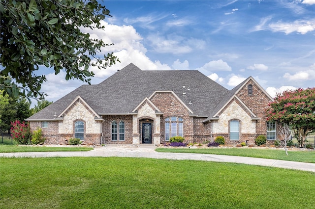 3517 Grants Lndg, Fort Worth, TX 76179 - french country style house with brick siding, roof with shingles, and a front lawn