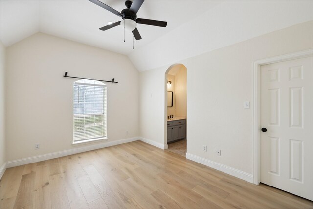3517 Grants Lndg, Fort Worth, TX 76179 - unfurnished bedroom featuring arched walkways, lofted ceiling, light wood finished floors, baseboards, and ensuite bathroom