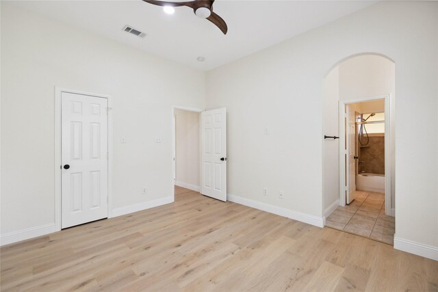 3517 Grants Lndg, Fort Worth, TX 76179 - unfurnished bedroom with arched walkways, light wood-type flooring, ensuite bathroom, baseboards, and a ceiling fan