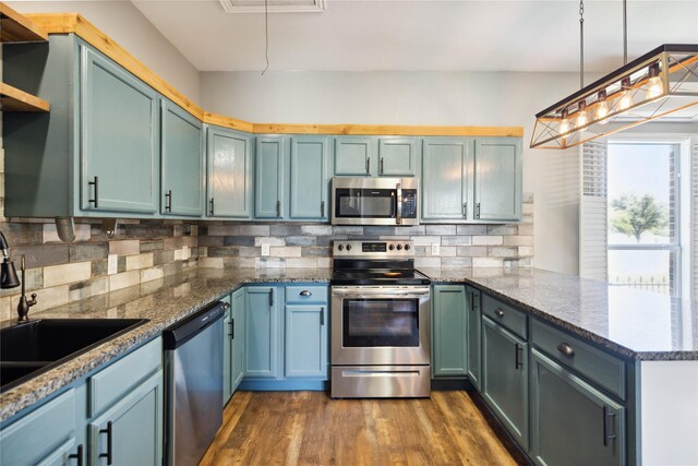 3517 Grants Lndg, Fort Worth, TX 76179 - kitchen with stainless steel appliances, a peninsula, a sink, dark wood-style flooring, and open shelves