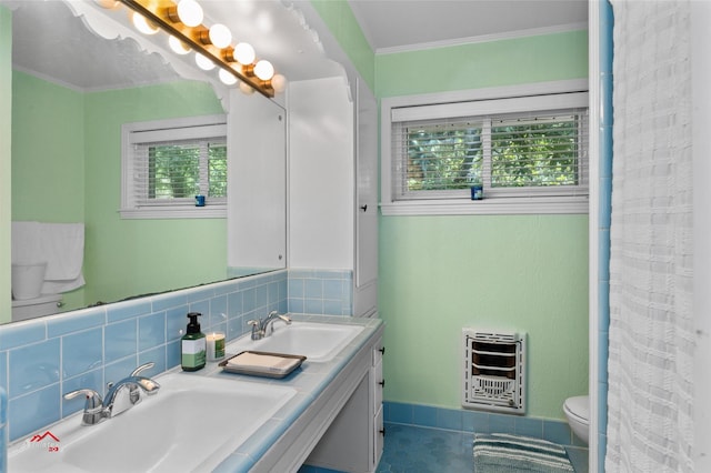 6237 Dillingham Ave, Shreveport, LA 71106 - bathroom with heating unit, toilet, crown molding, double vanity, and decorative backsplash