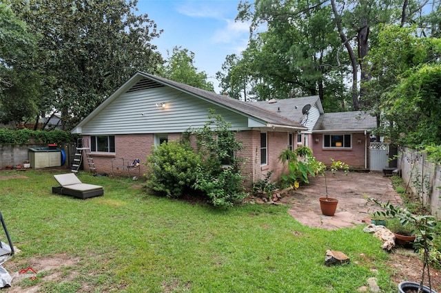 6237 Dillingham Ave, Shreveport, LA 71106 - rear view of house with brick siding and a patio area