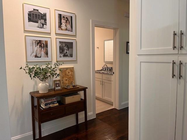 406 Barnes St, Mckinney, TX 75069 - hall featuring dark wood finished floors, a sink, and baseboards