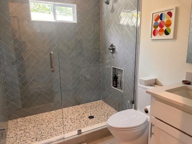 406 Barnes St, Mckinney, TX 75069 - bathroom featuring a shower stall, toilet, and vanity