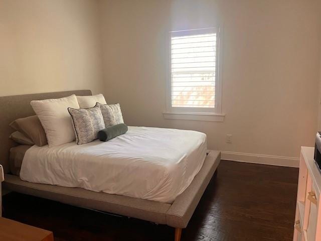 406 Barnes St, Mckinney, TX 75069 - bedroom with baseboards and dark wood-style flooring