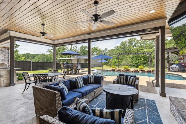 7404 Sandy Lake Rd, Quinlan, TX 75474 - fenced backyard with outdoor dining area, an outdoor hangout area, a ceiling fan, and a patio area