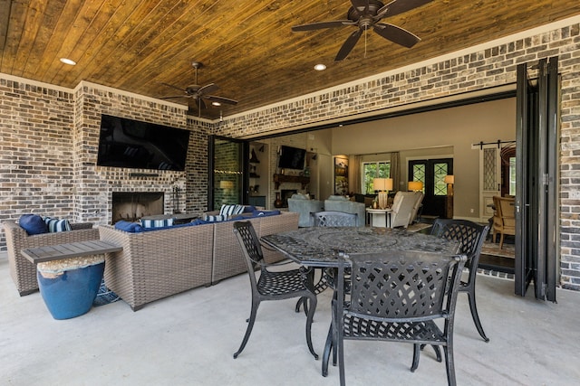 7404 Sandy Lake Rd, Quinlan, TX 75474 - view of patio with a ceiling fan, an outdoor living space with a fireplace, and outdoor dining space