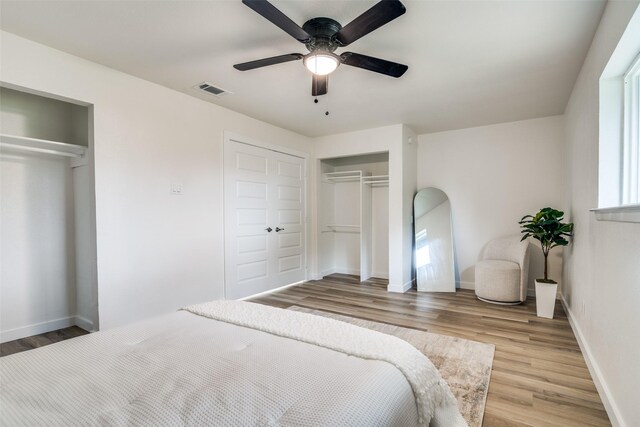 1106 Spring Lake Dr, Garland, TX 75043 - bedroom with wood finished floors, a ceiling fan, baseboards, and a closet