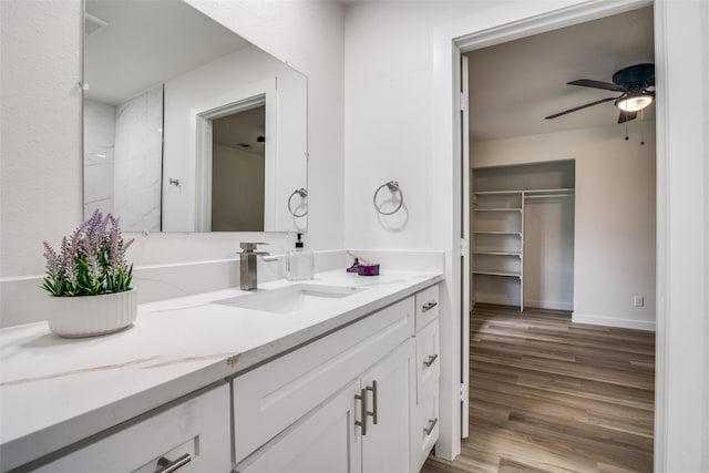 1106 Spring Lake Dr, Garland, TX 75043 - bathroom featuring vanity, wood finished floors, ceiling fan, and baseboards