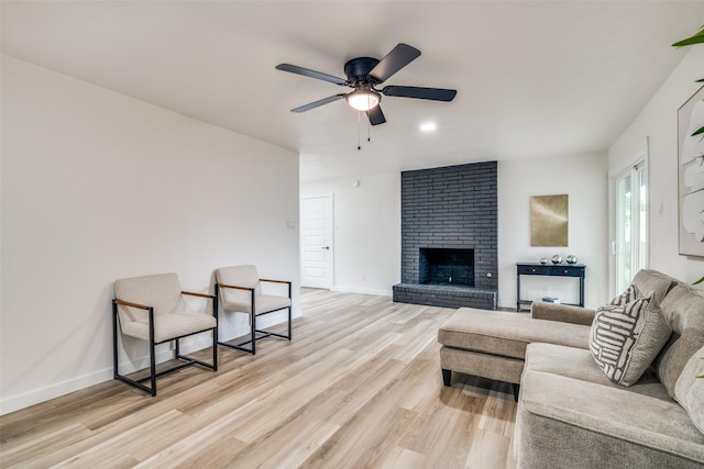 1106 Spring Lake Dr, Garland, TX 75043 - living area with light wood-style flooring, a ceiling fan, baseboards, and a fireplace