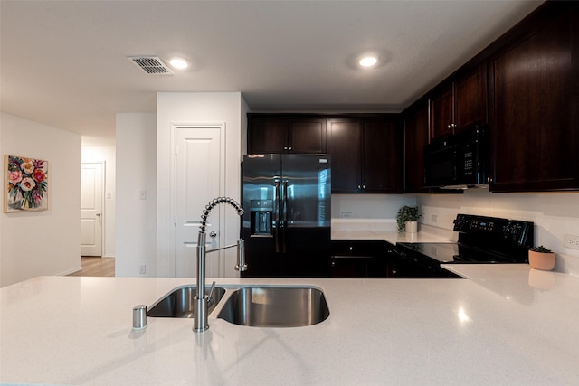 723 Cochran Dr, Princeton, TX 75407 - kitchen featuring black appliances, a sink, light countertops, dark brown cabinetry, and recessed lighting