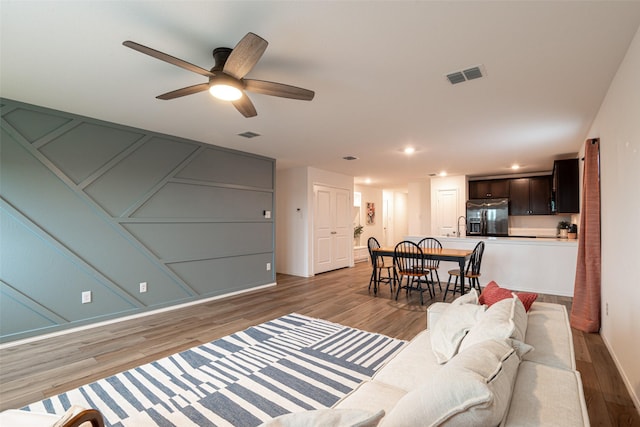 723 Cochran Dr, Princeton, TX 75407 - living room with light wood finished floors, ceiling fan, and recessed lighting