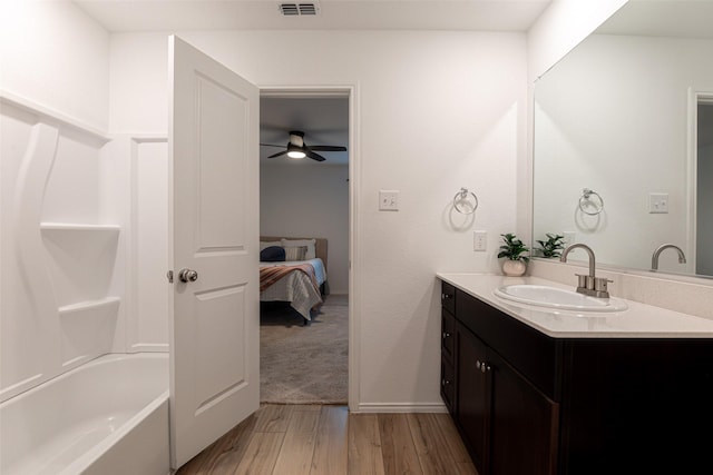 723 Cochran Dr, Princeton, TX 75407 - full bath with vanity, wood finished floors, ensuite bath, a ceiling fan, and bathtub / shower combination