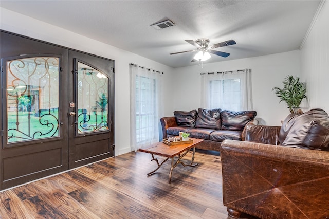 606 Quiram Ln, Kemp, TX 75143 - living area with french doors, dark wood-type flooring, plenty of natural light, and a ceiling fan