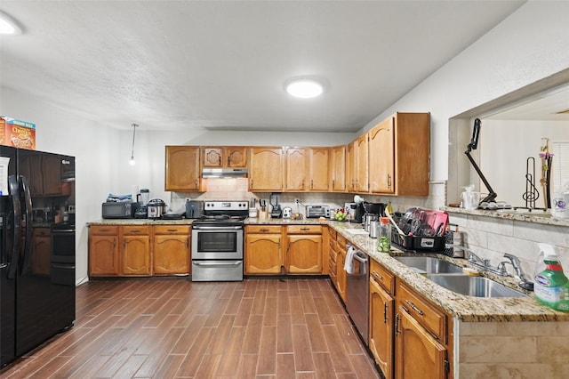 407 Mckinley St, Cedar Hill, TX 75104 - kitchen with black appliances, a sink, under cabinet range hood, decorative backsplash, and light stone counters