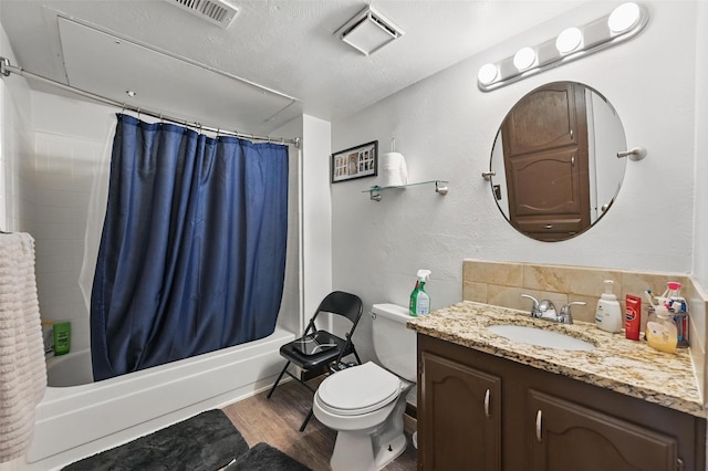 407 Mckinley St, Cedar Hill, TX 75104 - bathroom with vanity, shower / bath combination with curtain, toilet, wood finished floors, and a textured ceiling