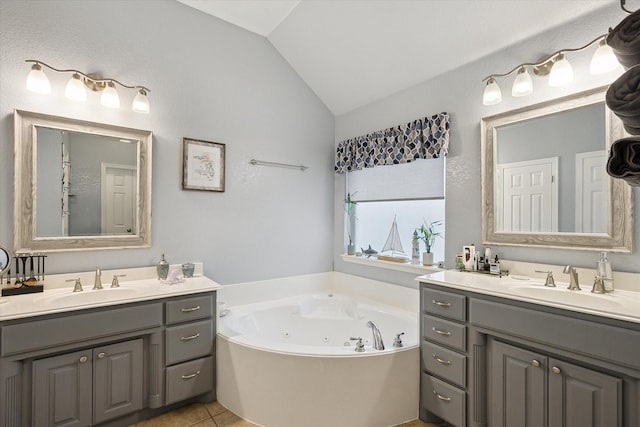 568 Willowview Dr, Saginaw, TX 76179 - bathroom with lofted ceiling, two vanities, a tub with jets, and tile patterned flooring