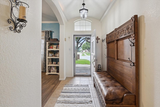 568 Willowview Dr, Saginaw, TX 76179 - foyer featuring vaulted ceiling, arched walkways, ornamental molding, a textured wall, and baseboards